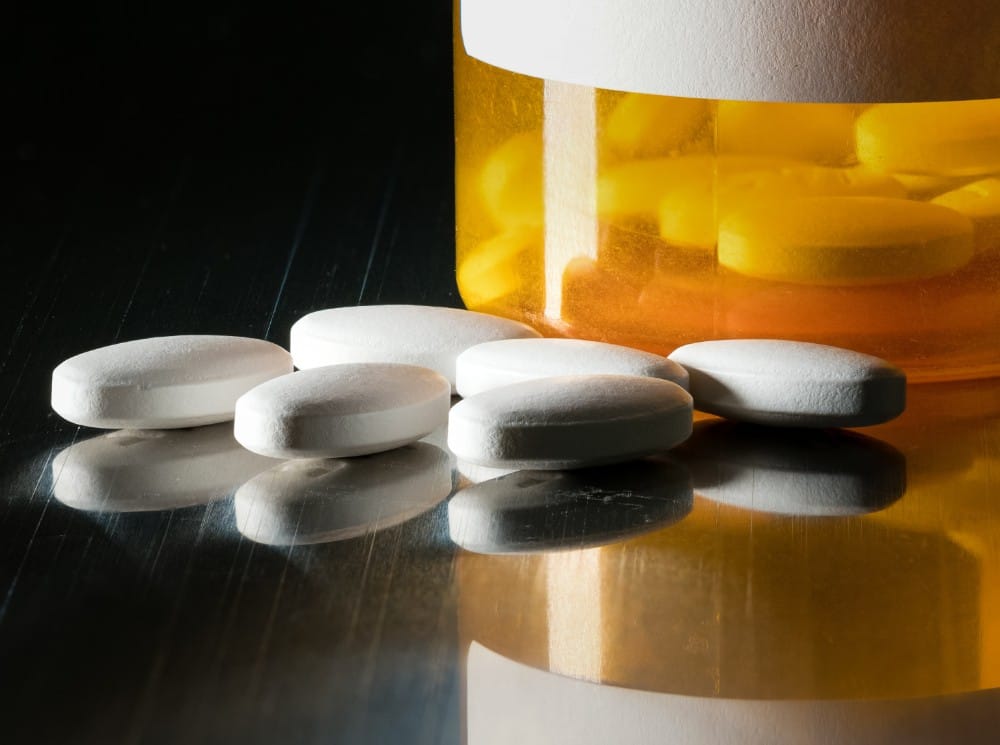Pills laying outside of a bottle